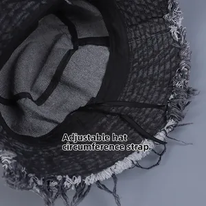Detail of adjustable inner drawstring and frayed edges on washed denim bucket hat