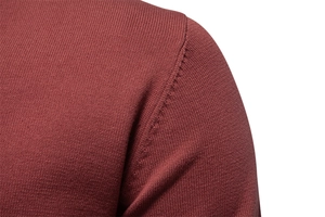 Detail view of the durable shoulder seam and premium knit texture on red V-neck sweater