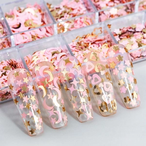 Detailed view of pink and gold nail art sequins with heart and flower shapes on tips