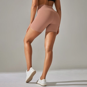 Close-up of high-waisted pink yoga shorts showing seamless scrunch butt lifting detail