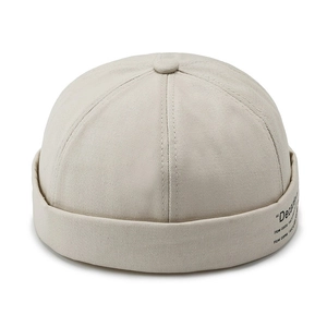 Beige cotton docker hat with minimalist embroidery in a clean top-view studio shot