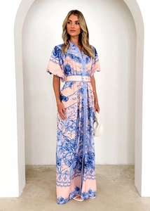 Detail view of pink and blue floral print dress with button-up collar and waist belt