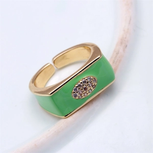 Macro view of adjustable gold ring with green enamel inlay and sparkling zircon stones
