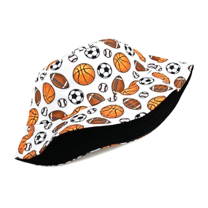 Close-up of white bucket hat with basketball and football prints featuring black lining