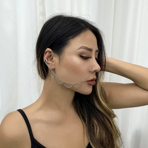 Detail showing punk silver metal ear cuff to nose ring connection with triple fringe chains