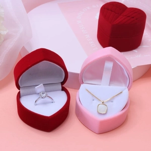 Macro detail of red heart-shaped velvet jewelry boxes for wedding rings and necklaces