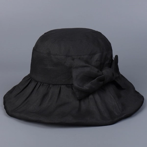Detail of elegant black ramie sun hat showing large bow and breathable fabric texture
