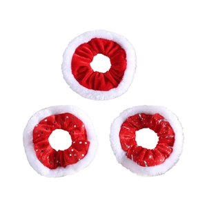 Three Christmas plush velvet scrunchies with white faux fur trim and silver star patterns
