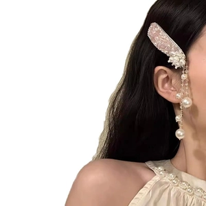 Elegant pearl tassel hair clip with pink crystal details worn on model hair side