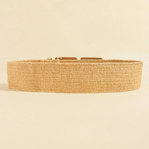 Detailed texture of bohemian straw woven belt with a round geometric wooden buckle