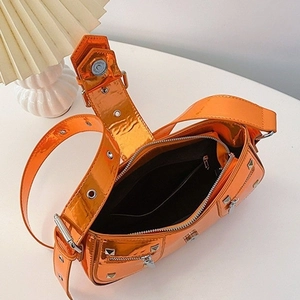 Orange glossy patent leather motorcycle shoulder bag with stud details and zipper accents