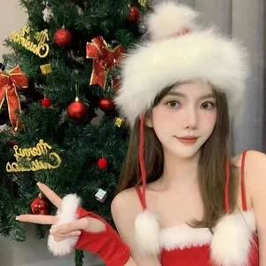 Women's festive red Christmas beanie with plush white trim and pom-pom strings