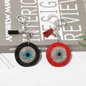 Detailed view of evil eye keychains with sparkling rhinestones and matching silk tassels