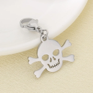 Close-up of a polished stainless steel skull and crossbones pendant with lobster clasp