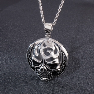 Detailed macro view of vintage skull pendant with tribal patterns on twisted chain