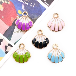 Five shell-shaped DIY jewelry charms with colorful enamel stripes and gold metal edges