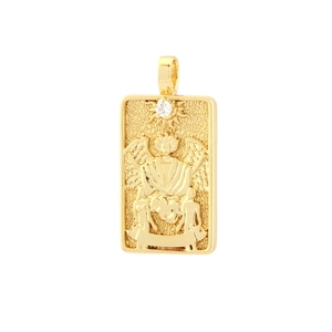 Macro detail of gold plated tarot card pendant with winged figure and white zircon inlay