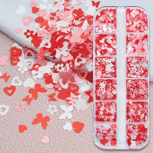 Detailed view of 12-grid nail art sequins with heart, butterfly and flower shapes
