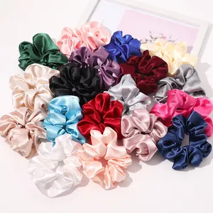 Macro shot of assorted colorful satin silk scrunchies with elegant glossy texture