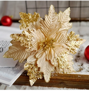 Macro view of champagne gold sequined poinsettia flower with sparkling glitter finish