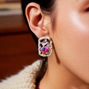 Close-up of vintage square earrings with colorful glass beads and sparkling crystals