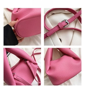 Close-up of pink lychee textured leather handbag with silver hardware and adjustable straps