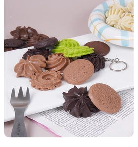 Macro detail of artificial cookie keychains with realistic textures on a white ceramic plate