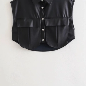 Women's black faux leather vest with lapel collar and dual front flap pockets