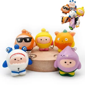Detailed view of colorful cartoon character pendants with metal keychains on a wooden stand