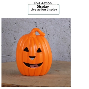 Close-up of lighted orange Halloween pumpkin lantern on a rustic wooden base