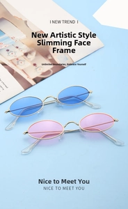 Detail view of oval retro sunglasses with metal frames in sky blue and soft pink lenses