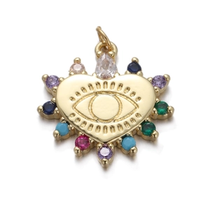 Detail of gold heart pendant with evil eye motif and colorful inlaid gemstones