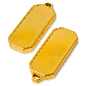 Macro shot of two polished gold rectangle 304 stainless steel pendants with beveled edges