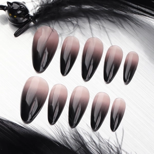 Short almond press-on nails with black French gradient and fine line art on silver base