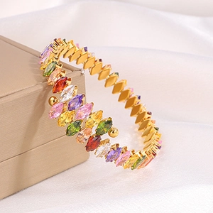 Macro detail of multicolored marquise-cut stones set in a luxury gold titanium bracelet