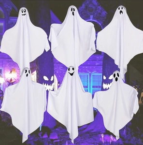 Six hanging Halloween white fabric ghosts with different expressions in front of purple lights