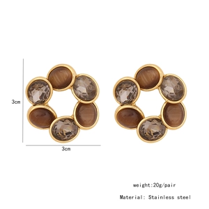 Détails de boucles d'oreilles vintage en acier doré avec pierre œil de chat et cristaux gris