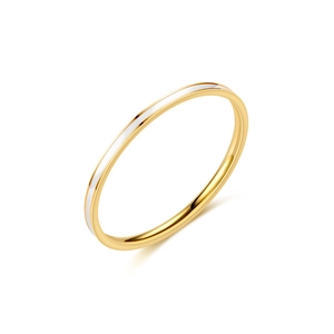 Close-up of minimalist gold and silver titanium steel slim ring with polished finish
