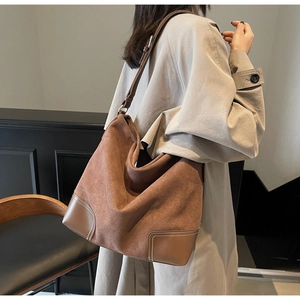 Brown suede tote bag on model showing large capacity and stylish casual shoulder fit