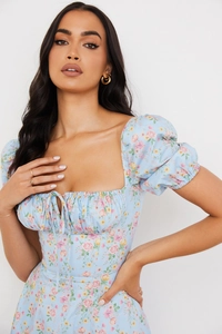 Detail of light blue floral dress showing puff sleeves and drawstring square neckline