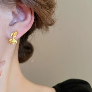 Detailed view of a gold-plated goldfish stud earring on a model in a modern Chinese style