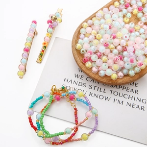 Close-up of pastel beaded bracelets and hair clips on a card with emotional quote