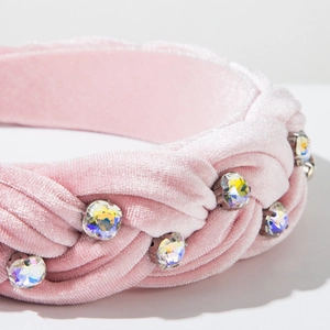 Close-up of pink velvet braided headband featuring sparkling rhinestones and woven texture