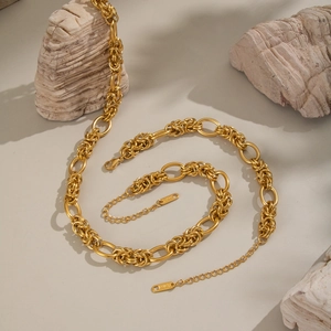 Polished 18K gold-plated stainless steel knot necklace on a natural stone background