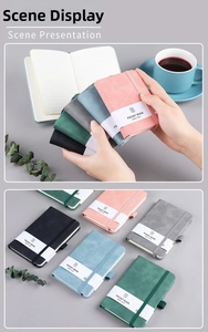 Close-up of portable pocket books with elastic straps and textured faux leather covers