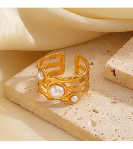 Detail of gold wave-shaped stainless steel ring with three irregular pearls