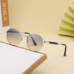 Women's round frame sunglasses with silver metal frame and gradient lenses on props