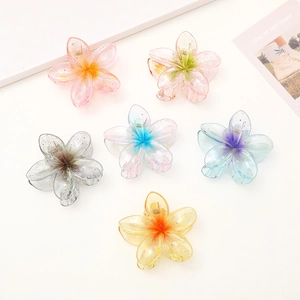 Colorful acrylic frangipani hair claws set with glitter finish on white background