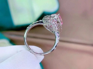 Detailed side view of a bird's nest cut pink morganite ring with pavé-set diamonds