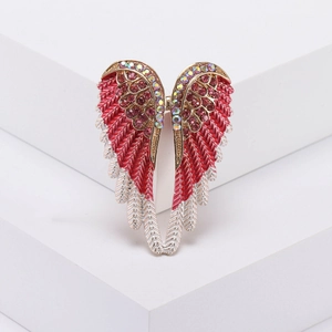 Elegant angel wing brooch with red and white enamel feathers and pink rhinestones